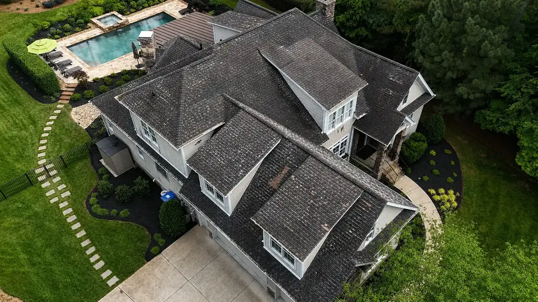 Before: aerial view of a worn, weathered roof prior to Integrity Roofing service